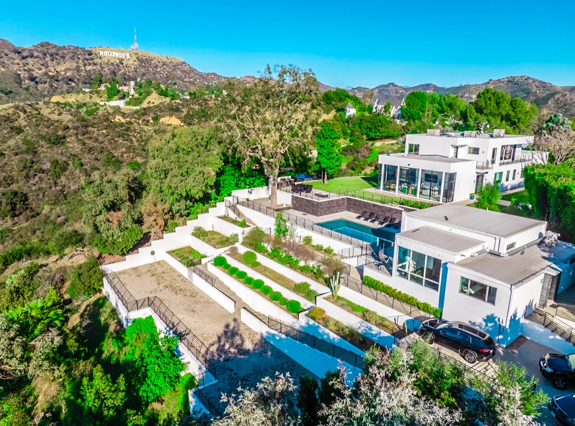 Bliss Recovery Luxury Rehab - bright living room with floor-to-ceiling windows and Hollywood Hills view