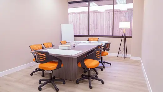 Bright conference room with orange chairs at Launch To Wellness - intensive outpatient program in Los Angeles.