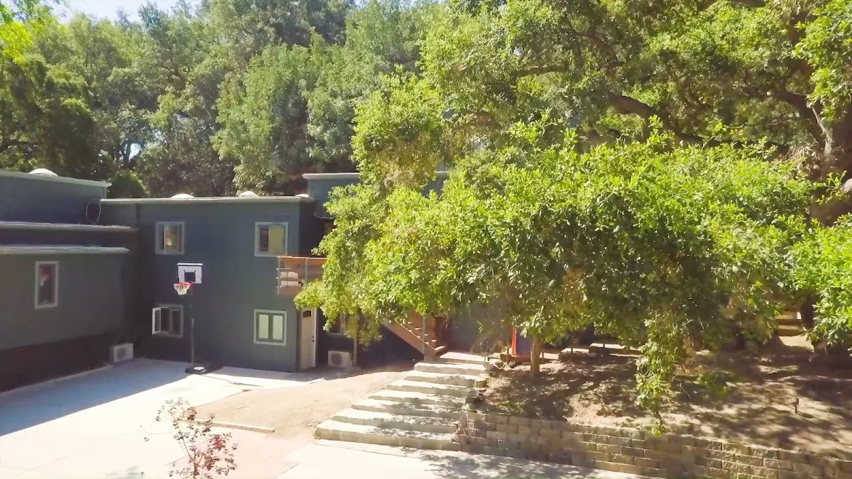 Lush outdoor space with basketball hoop at Oak Forest Recovery, a sober living home in Los Angeles.